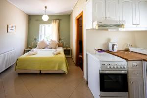 a small bedroom with a bed and a kitchen at Villa Muses in Poros