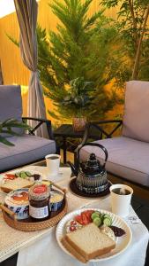 a table with two plates of food on it at أكواخ واستراحه ريف عسير in Abha +15 photos