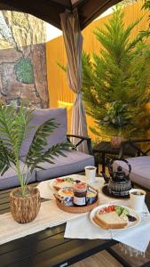 a table with plates of food on a patio at أكواخ واستراحه ريف عسير in Abha
