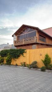 a house with a balcony on the side of it at أكواخ واستراحه ريف عسير in Abha