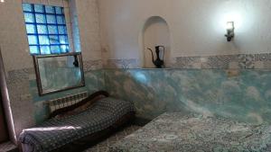 a bedroom with a bed and a mirror and a window at Номер у моря, бассейн, сад, мангал in Odesa +14 photos