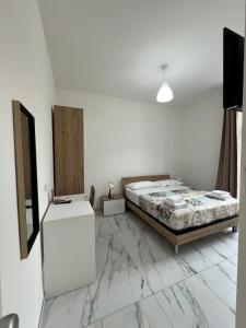 a bedroom with a bed and marble floor at Corte Moscara Vasto Centro in Vasto