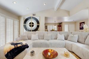 a living room with a white couch and a table at Palm Paradise in Palm Desert