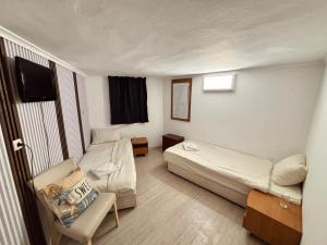 a small room with a bed and a couch at hostel FARA in Nesebar