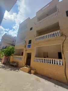 a brick building with balconies on the side of it at HASH # SAAd in Marsa Matruh