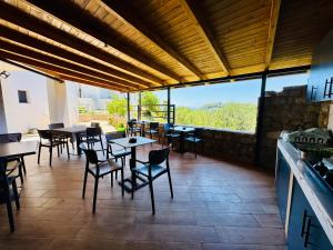 a restaurant with tables and chairs on a patio at Petros rooms in Himare