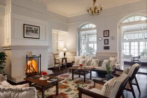 a living room with a couch and a fireplace at Singell Tea Estate - A CGH Earth Experience in Darjeeling