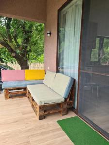 a porch with a bench and a window at MAG house in Shekhvetili
