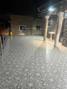 a room with a tiled floor in a building at Kingdom home in Amanfro