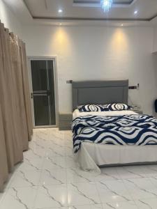 a bedroom with a bed and a tiled floor at Kingdom home in Amanfro