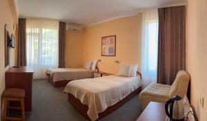 a hotel room with two beds and a window at Guest rooms Marina in Obzor