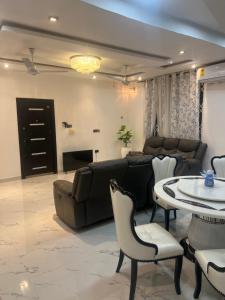a living room with a couch and a table at Kingdom home in Amanfro +5 photos