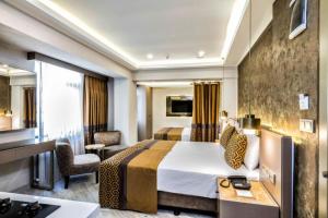 a hotel room with a king sized bed and a bathroom at Ayramin Deluxe Hotel - Anex in Istanbul