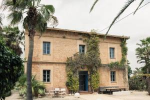 an old stone house with a table and chairs at Villa Station by Cassai in Ses Salines