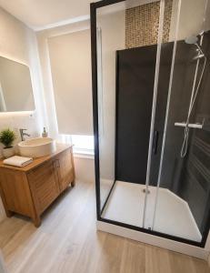 a bathroom with a shower and a sink at Frida's house in Bièvres