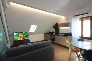 a living room with a couch and a table at Logis Hotel Domaine de Rouffach in Rouffach