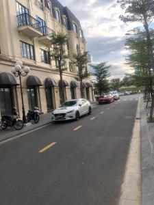 a white car parked on the side of a street at Gemstay Hotel Hue in Thôn Trường Giang