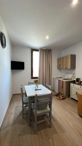 a dining room and kitchen with a table and chairs at La Vigna 1803 in Casa Gagliano