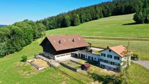 an aerial view of a large house in a field at La Boutique in Saignelégier