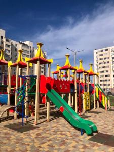 a colorful playground with a slide and a slideintend at New Marine Apartment in Yuzhne