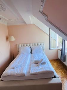 a large bed in a room with a large window at Vila Natalija in Ljubljana