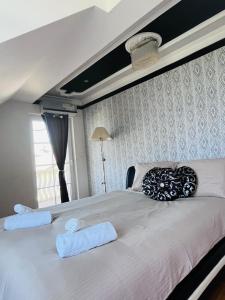 a bedroom with a large bed with two towels on it at Vila Natalija in Ljubljana +3 photos