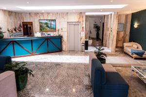 a lobby with blue couches and a blue counter at Aparthotel Imperatriz in Funchal