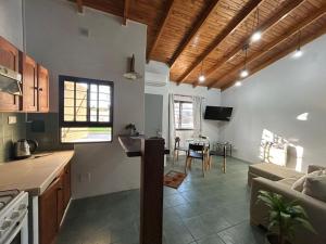 a kitchen and living room with a couch and a table at La Casita de Levene en Lobos in Lobos