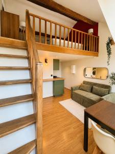 a living room with a staircase and a couch at Charming Duplex by Vincennes Castle in Vincennes