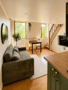 a living room with a couch and a table at Charming Duplex by Vincennes Castle in Vincennes