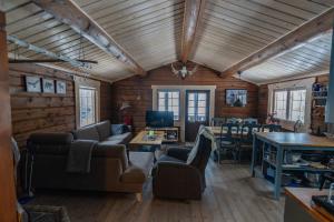 a living room with wooden walls and a wooden ceiling at Villa Fregn in Ljørdalen