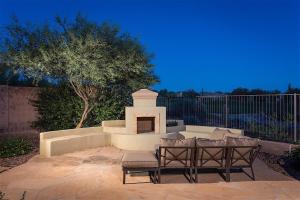 a patio with two chairs and a fireplace at Caledonia Dreamin in Phoenix