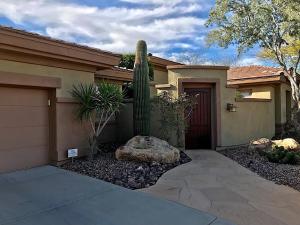a house with a cactus in front of a garage at Caledonia Dreamin in Phoenix