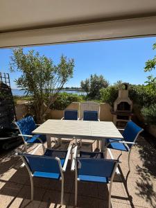 a white table and chairs on a patio at La mer en liberté in Gruissan