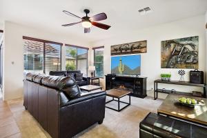 a living room with a couch and a ceiling fan at Getaway at Power Ranch in Gilbert +34 photos