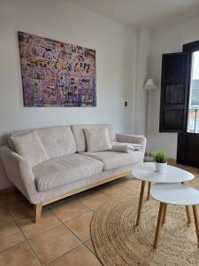 a living room with a couch and a table at Casa Velez in Vélez de Benaudalla