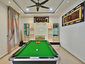 a pool table in a room with a ceiling fan at Large Group KTV Stay, Near Setia Alam, Klang in Klang