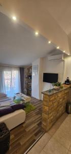 a living room with a couch and a tv in a room at Lavanda Sea View Apartment Mali Lošinj in Mali Lošinj