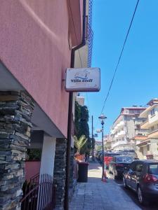a sign for a wine shop on the side of a building at Guest house Villa Stefi in Sozopol