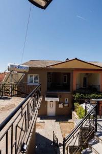 a house with a balcony and stairs in front of it at Konitsa Valley in Konitsa