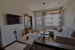 a living room with a couch and a table at Konitsa Valley in Konitsa
