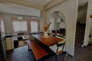 a kitchen and living room with a wooden table at Konitsa Valley in Konitsa