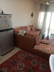 a living room with a couch and a refrigerator at Tahiti North coast kilo 62 in Borg El Arab +14 photos