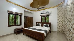 a bedroom with a bed and two windows at Sangeetha Private Pool Villa in Auroville