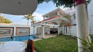 a house with a swimming pool in front of it at Sangeetha Private Pool Villa in Auroville