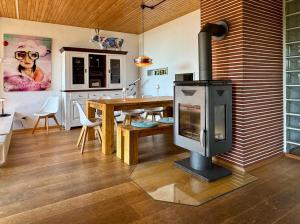 a living room with a wood burning stove in it at Alpenblick-Hotzenwald in Rickenbach