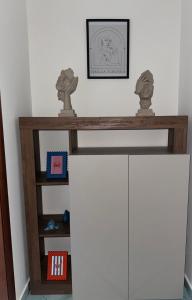 a shelf above a white cabinet in a room at Sibilla Flegrea in Pozzuoli