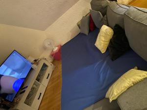 a bed in a room with a laptop on it at Cœur de Troyes studio in Troyes