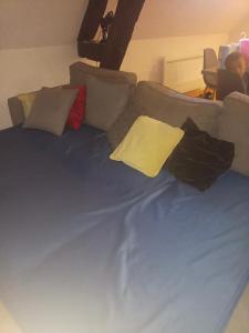 a blue bed with pillows on a couch at Cœur de Troyes studio in Troyes