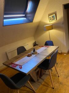 a table in a room with chairs around it at Cœur de Troyes studio in Troyes